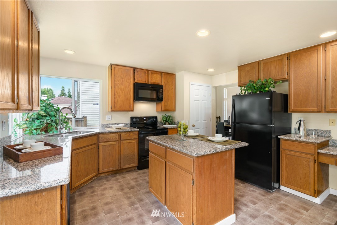 19104 113th Way Southeast Renton, WA 98055 - Photo 6 of 30 a kitchen with a sink stove and refrigerator