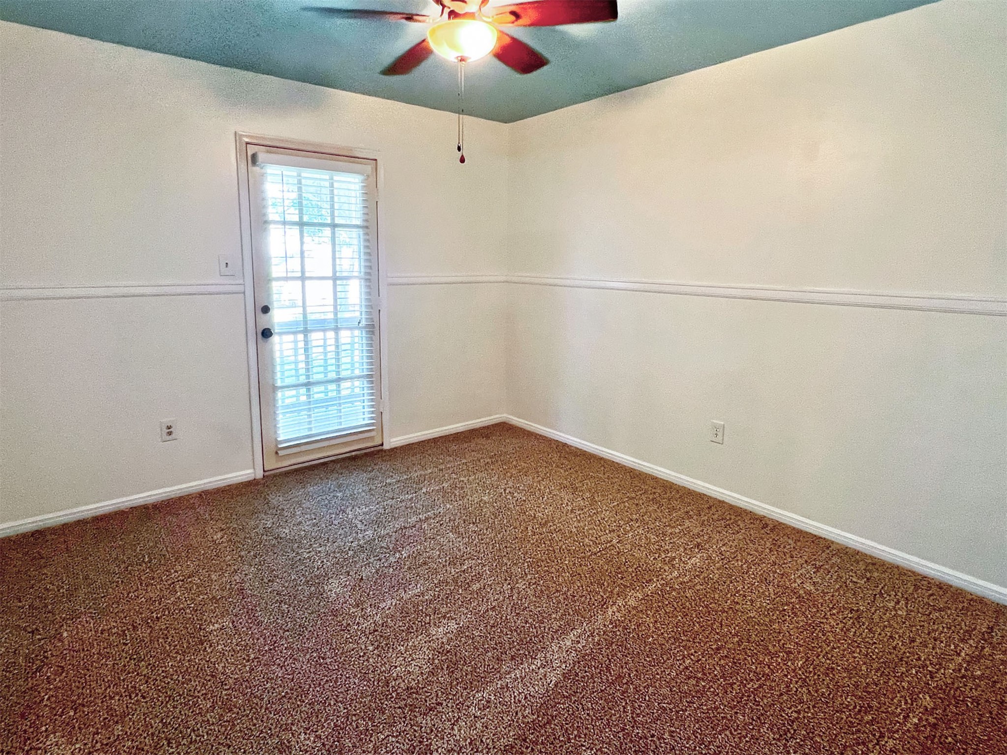16902 Summit Oaks Lane Spring, TX 77379 - Photo 33 of 49 an empty room with windows and chandelier fan