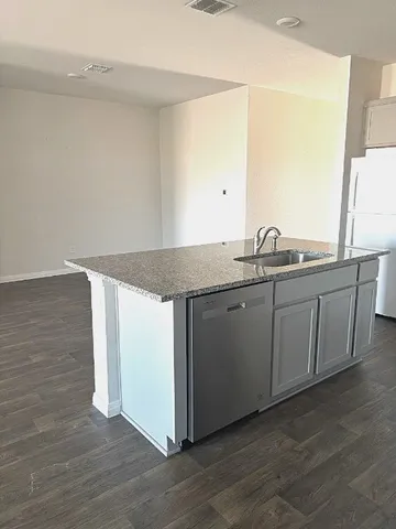 a kitchen with a sink and a mirror