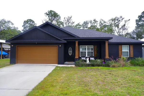 a front view of a house with garden