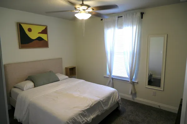 a bedroom with a bed and a chandelier