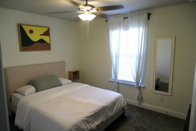 a bedroom with a bed and a chandelier