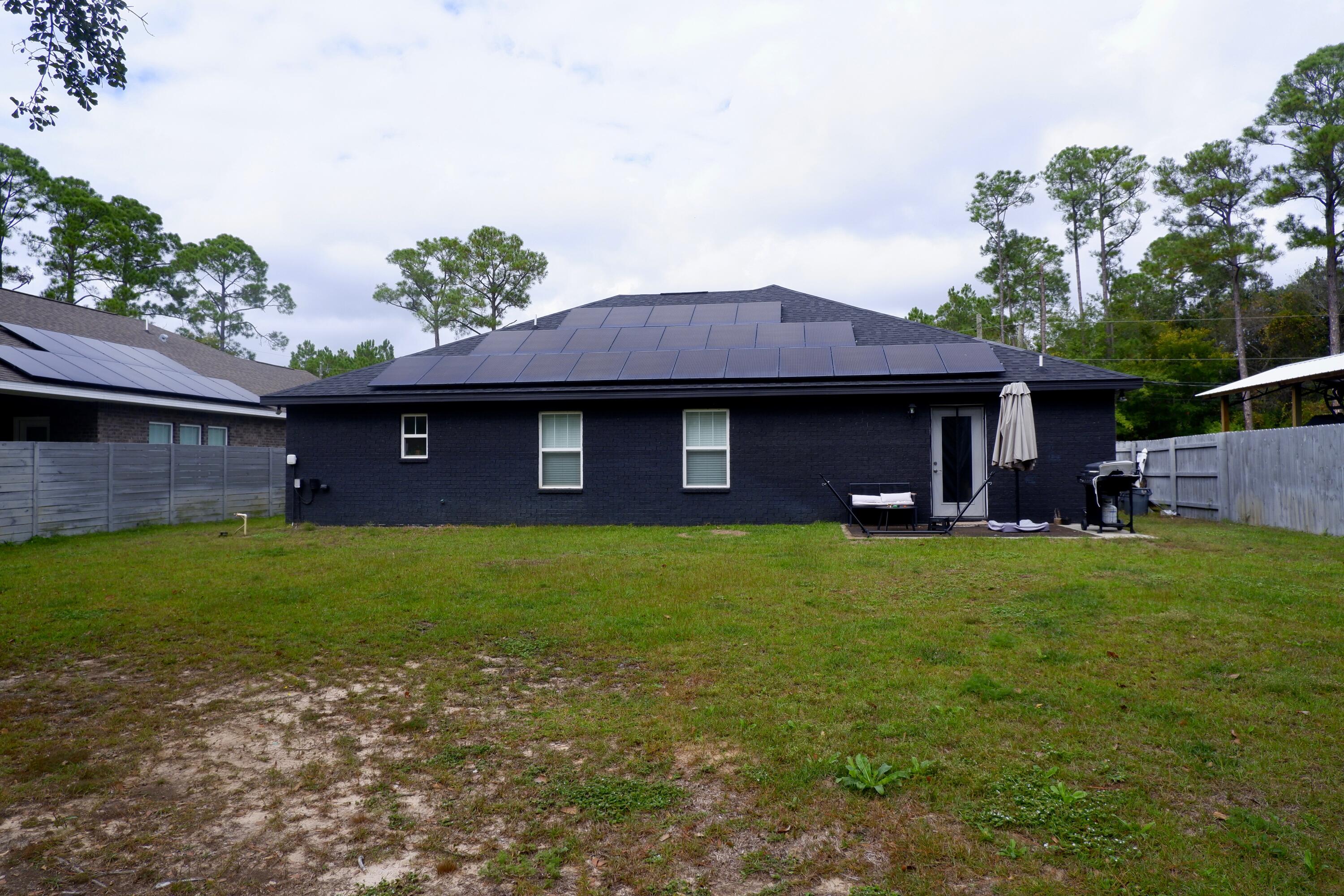 6841 Nelson Street Navarre, FL 32566 - Photo 14 of 14 a front view of a house with a garden