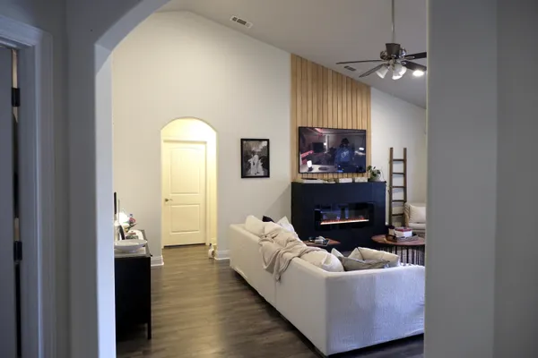 a living room with furniture and a chandelier