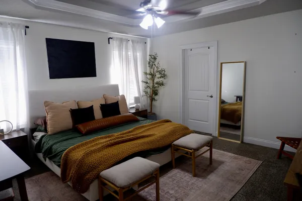 a bedroom with a bed a desk and chair