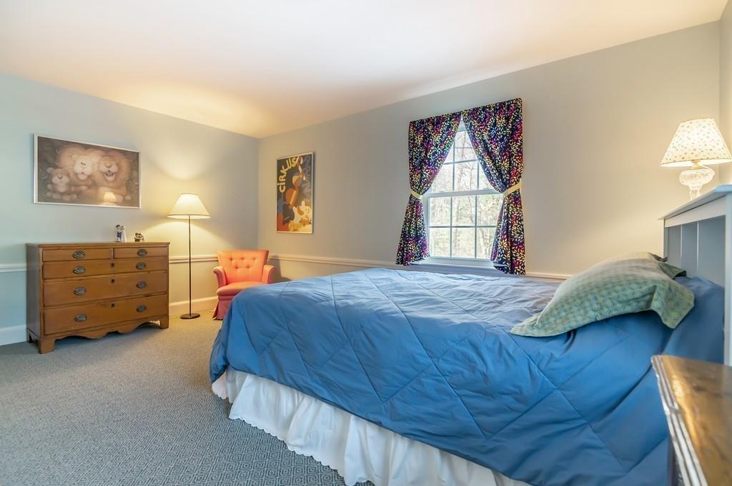15 Arcadia Road Andover, MA 01810 - Photo 30 of 42 a bedroom with a bed a dresser and a window