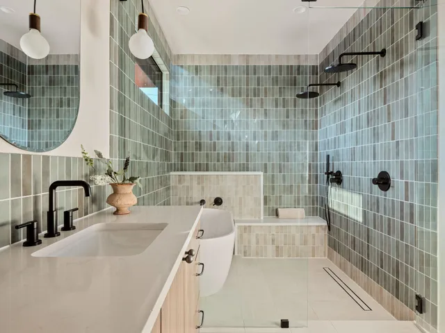a bathroom with a sink vanity mirror and toilet