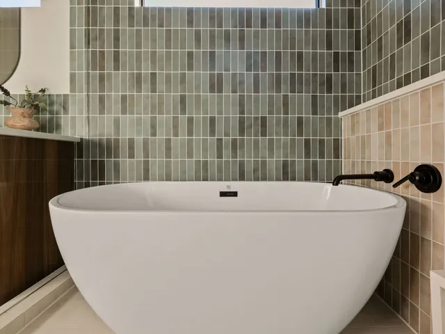 a bathroom with a granite countertop toilet sink and mirror