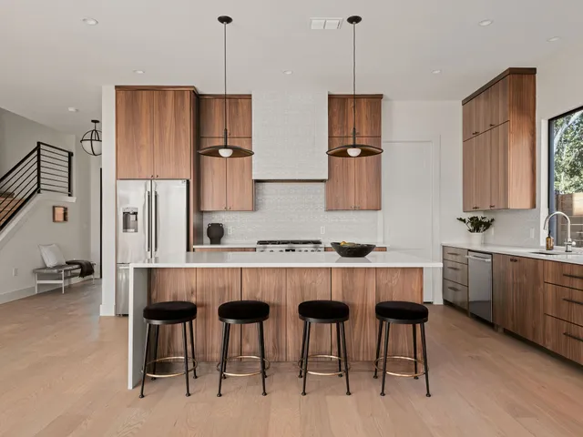 a kitchen with stainless steel appliances a sink stove and cabinets