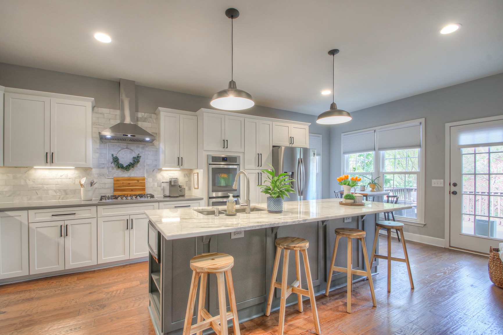 529 Crofton Park Lane Franklin, TN 37069 - Photo 15 of 59 a kitchen with stainless steel appliances granite countertop a stove a sink a refrigerator a dining table and chairs with wooden floor