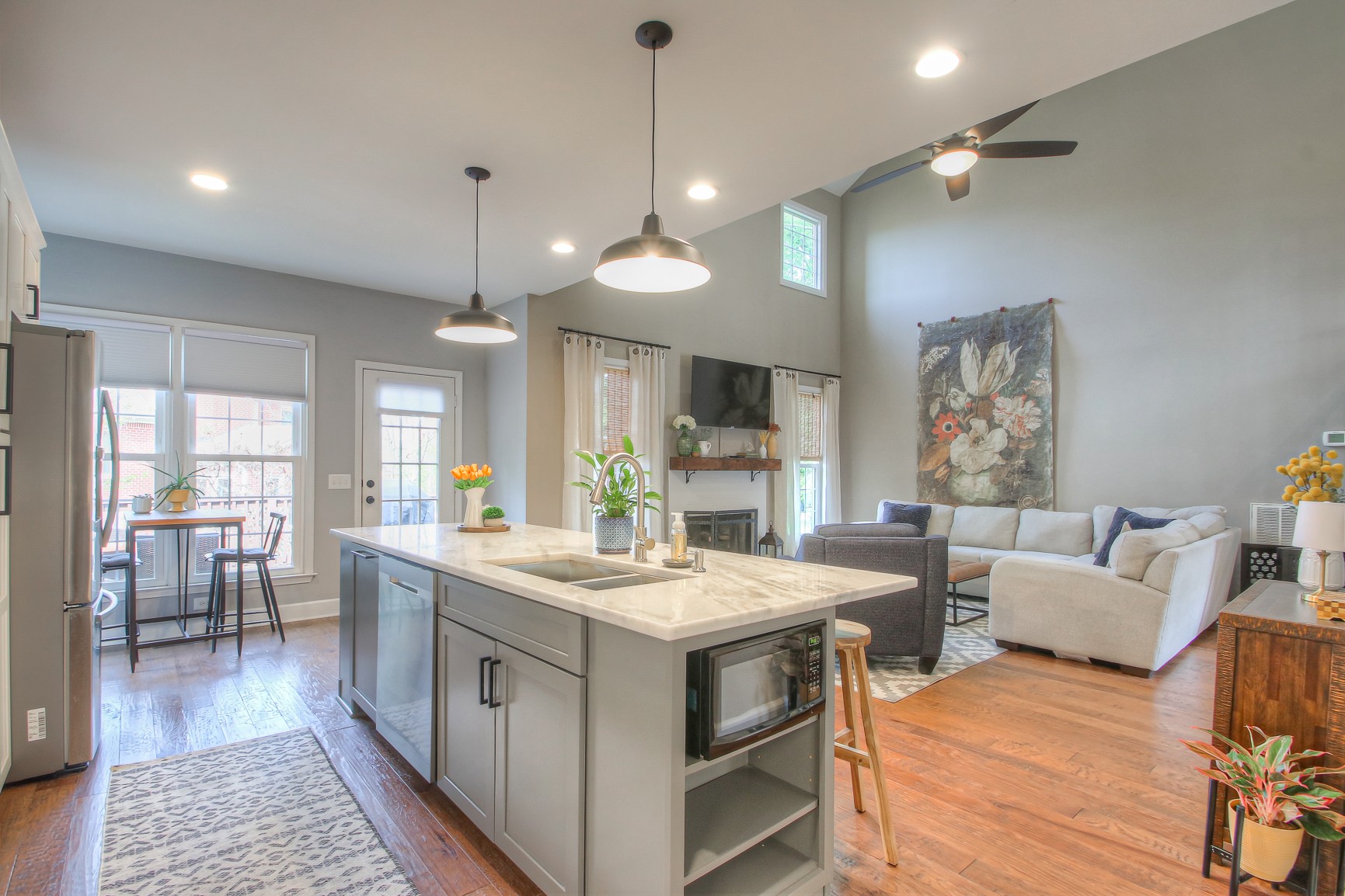 529 Crofton Park Lane Franklin, TN 37069 - Photo 17 of 59 a large kitchen with kitchen island a stove a sink a dining table and chairs with wooden floor