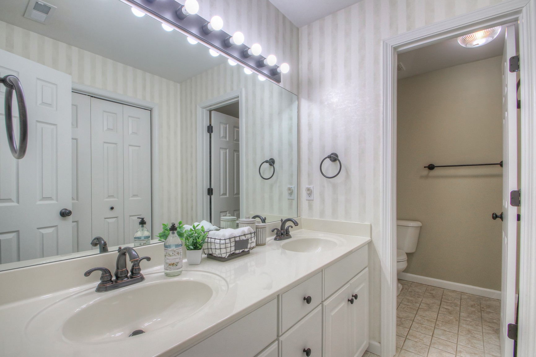 529 Crofton Park Lane Franklin, TN 37069 - Photo 35 of 59 a bathroom with a double vanity sink and a mirror
