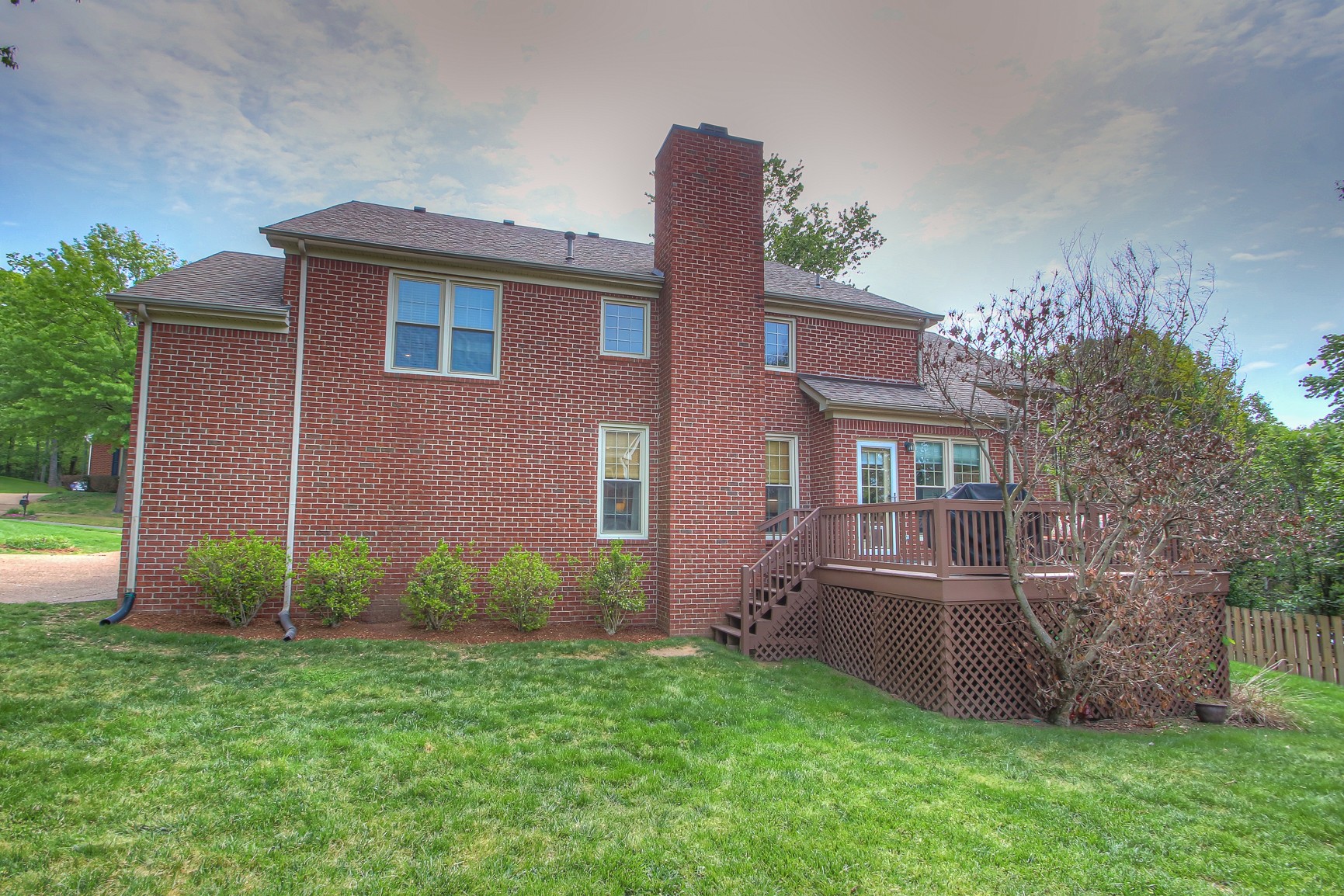 529 Crofton Park Lane Franklin, TN 37069 - Photo 53 of 59 a view of a brick house with a yard potted plants and large tree