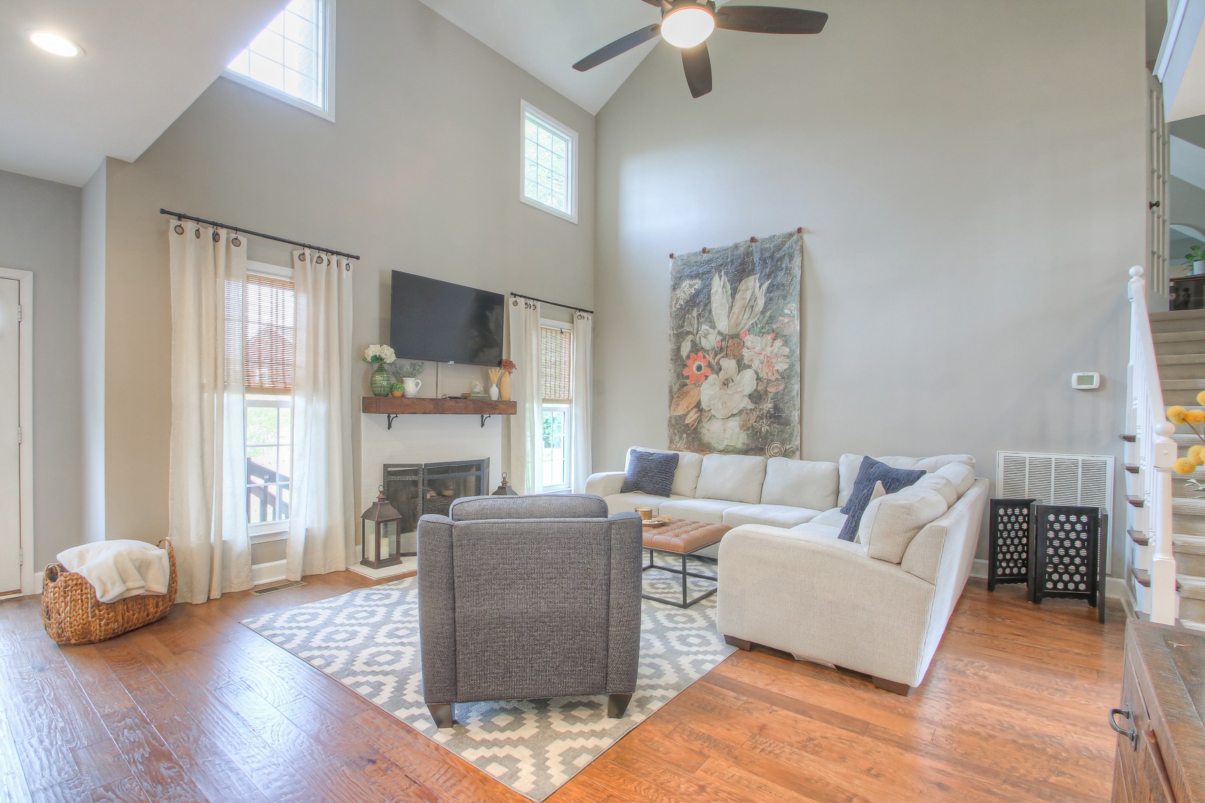 529 Crofton Park Lane Franklin, TN 37069 - Photo 9 of 59 a living room with furniture a fireplace and a chandelier