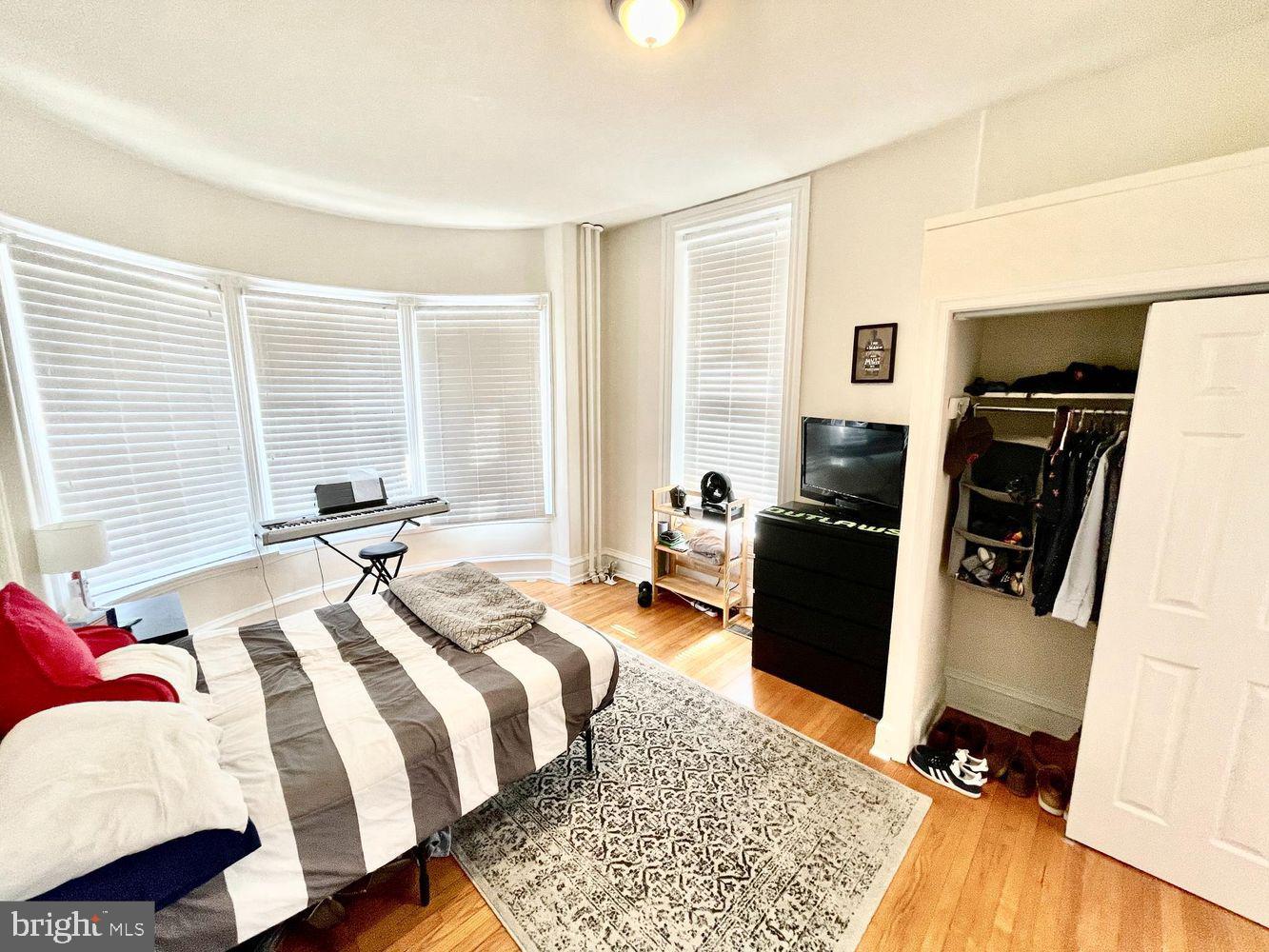 130 Green Lane, Unit 1 Philadelphia, PA 19127 - Photo 5 of 10 a bedroom with a bed and wooden floor