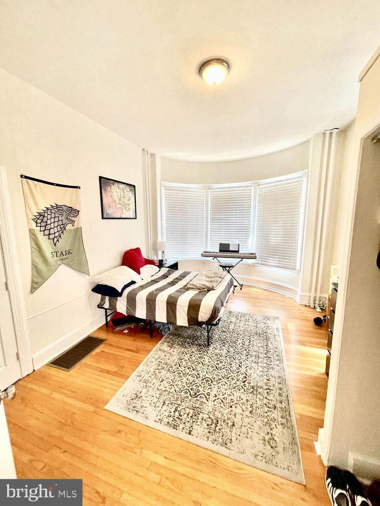 130 Green Lane, Unit 1 Philadelphia, PA 19127 - Photo 6 of 10 a bedroom with a bed and wooden floor