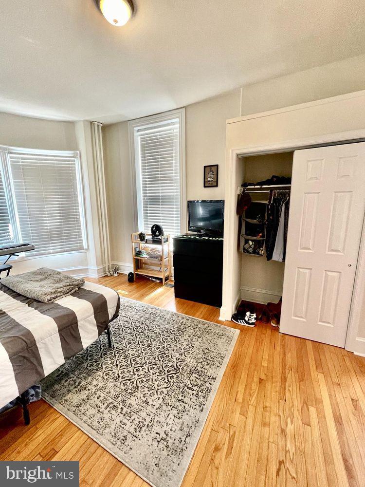 130 Green Lane, Unit 1 Philadelphia, PA 19127 - Photo 7 of 10 a bedroom with a bed and wooden floor