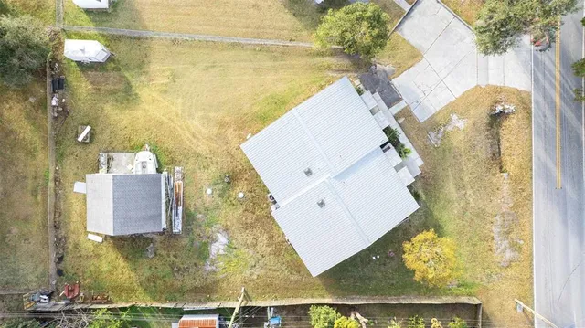 an aerial view of a house with garden space and street view