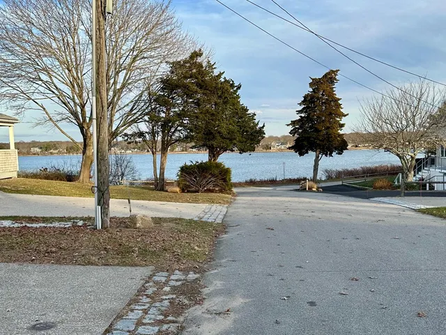 a view of a street with a building and trees