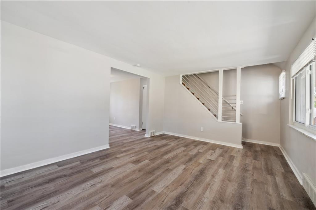 357 Collins Drive Pittsburgh, PA 15235 - Photo 3 of 23 an empty room with wooden floor and windows