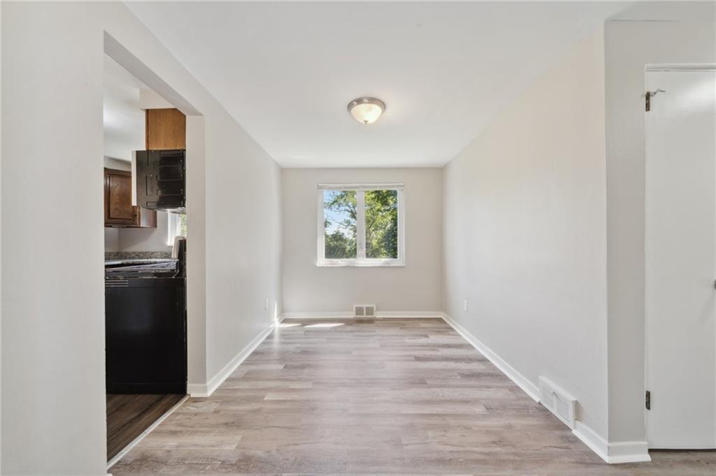 357 Collins Drive Pittsburgh, PA 15235 - Photo 6 of 23 a view of a kitchen with wooden floor electronic appliances and window