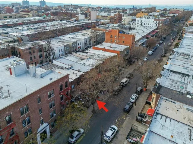 an aerial view of multiple houses with yard