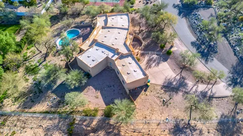 an aerial view of a backyard with swimming pool