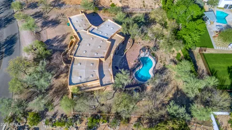 an aerial view of a house with a yard