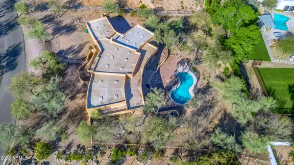 an aerial view of a house with a yard