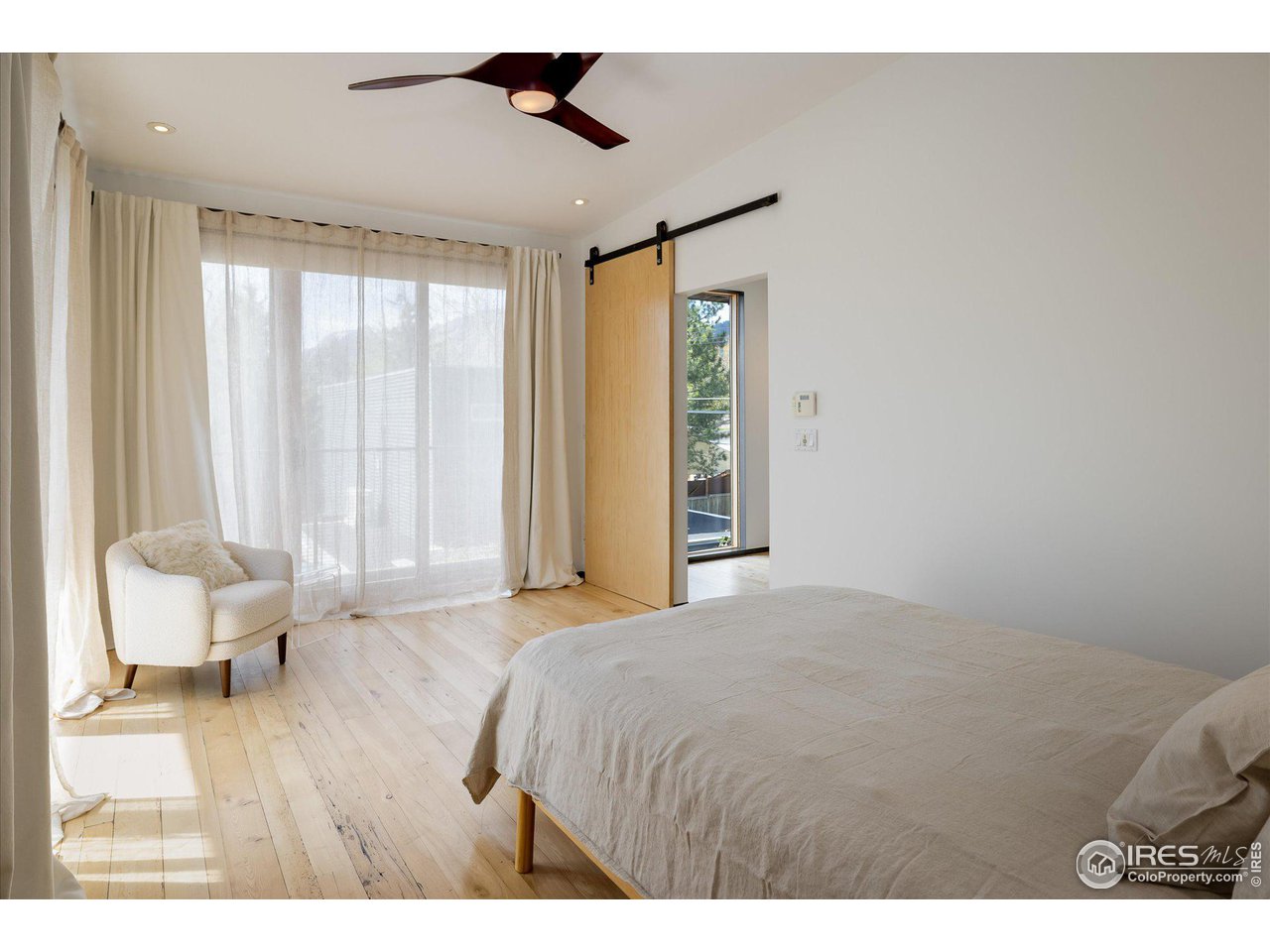 1740 Cedar Avenue Boulder, CO 80304 - Photo 20 of 40 a bedroom with a bed and wooden floor