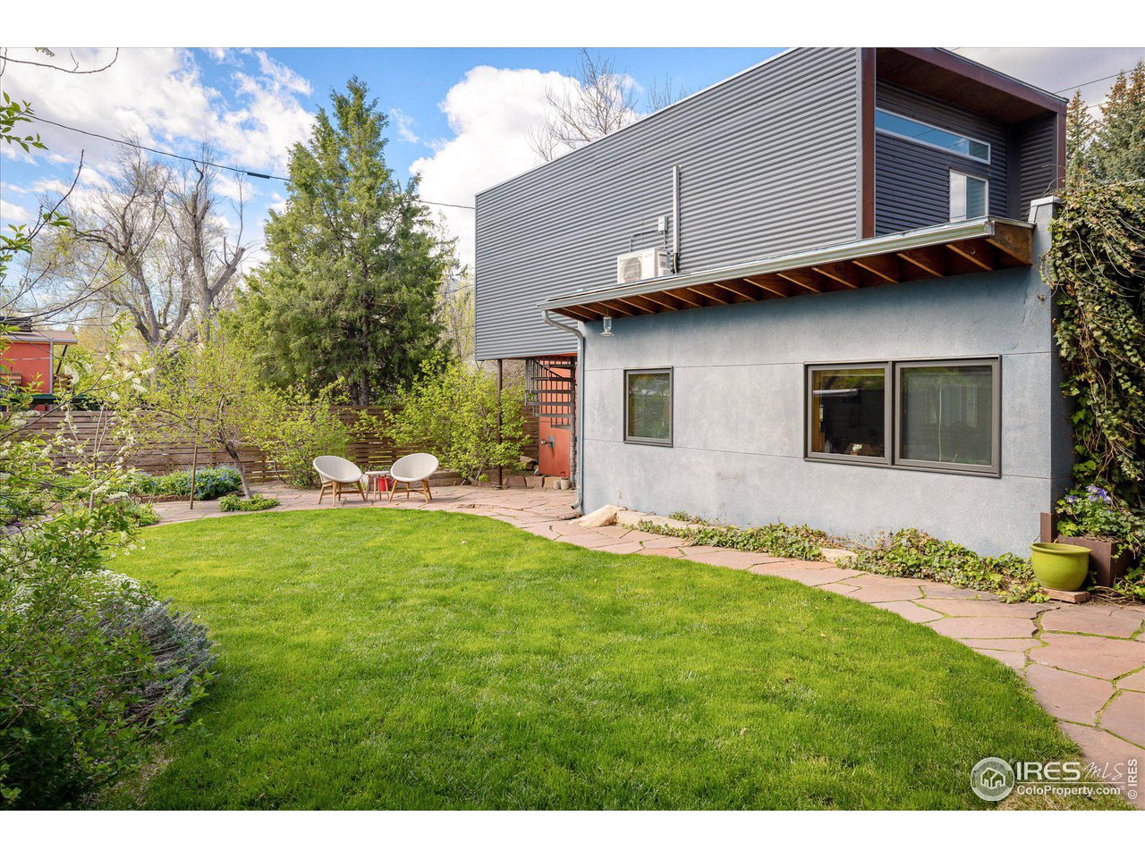 1740 Cedar Avenue Boulder, CO 80304 - Photo 36 of 40 a view of a backyard with potted plants and a table and chair