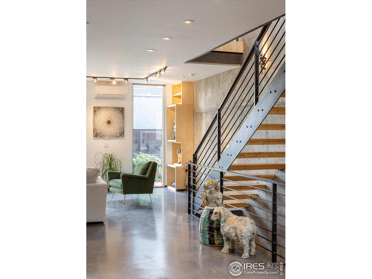 1740 Cedar Avenue Boulder, CO 80304 - Photo 5 of 40 a hallway with a couches and dining table with wooden floor