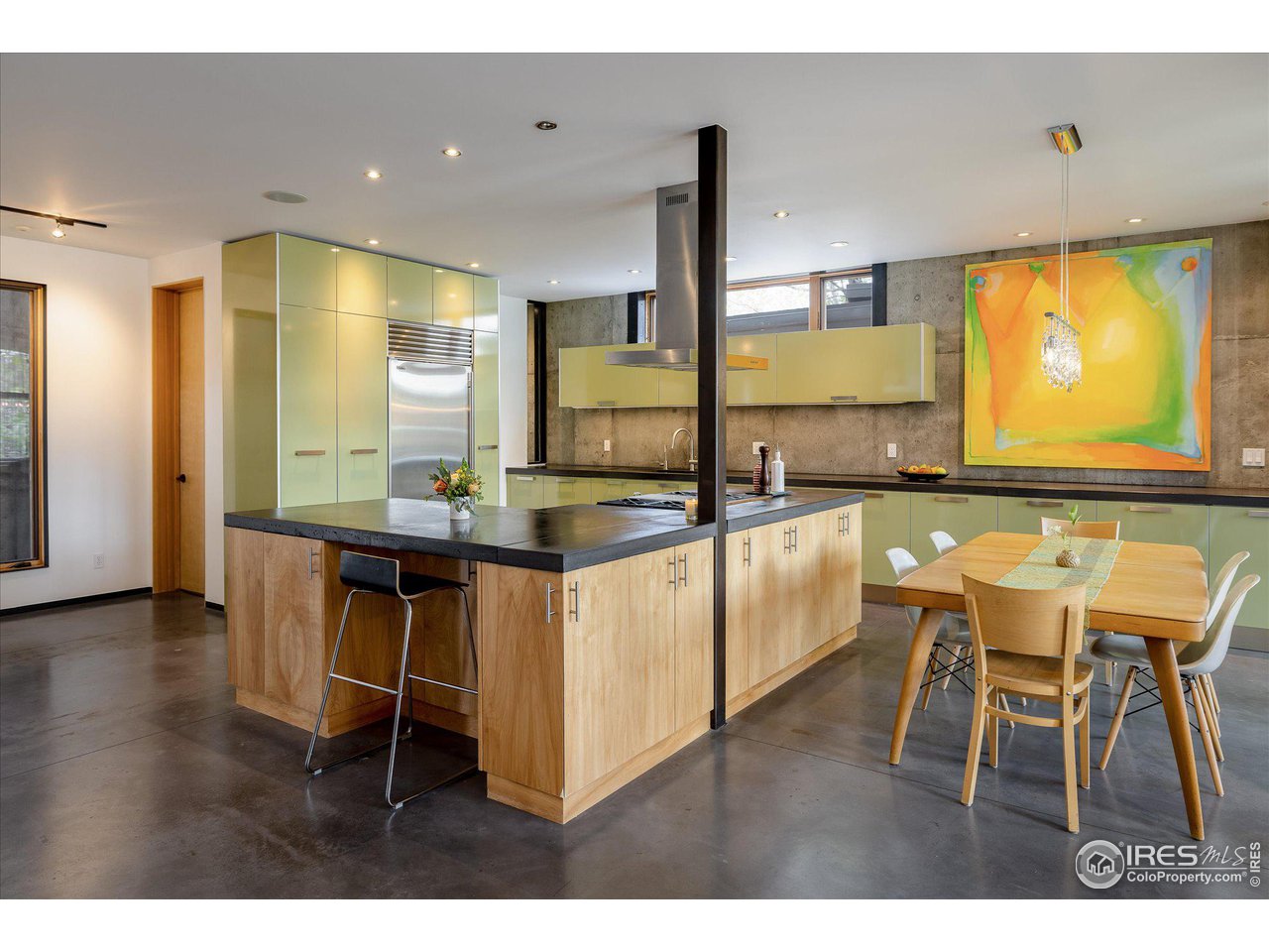 1740 Cedar Avenue Boulder, CO 80304 - Photo 10 of 40 a kitchen with kitchen island granite countertop a table chairs sink and cabinets