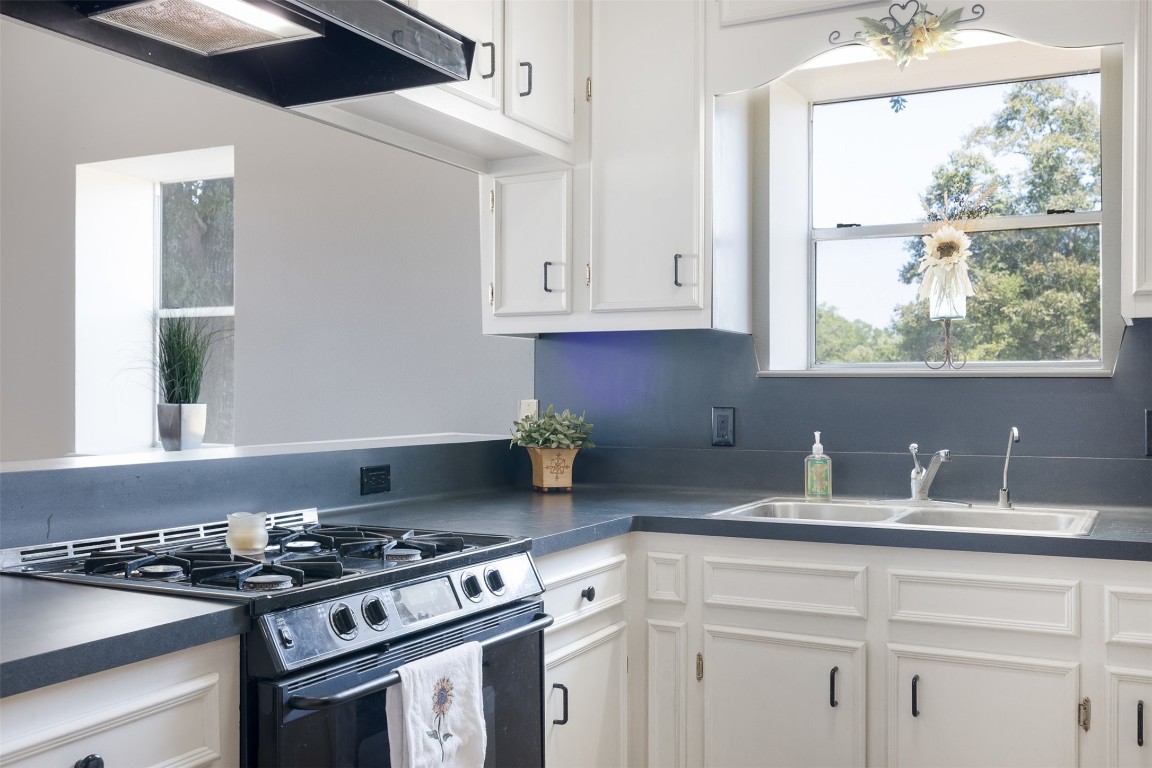 224 Fm 954 Road Round Top, TX 78954 - Photo 36 of 40 a kitchen with granite countertop a stove and a sink