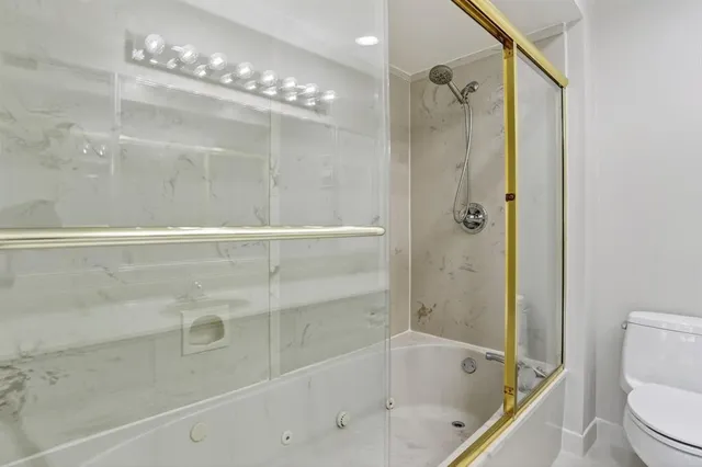 a kitchen with stainless steel appliances a sink a window and cabinets