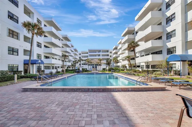 a bedroom with a large bed and a book shelf