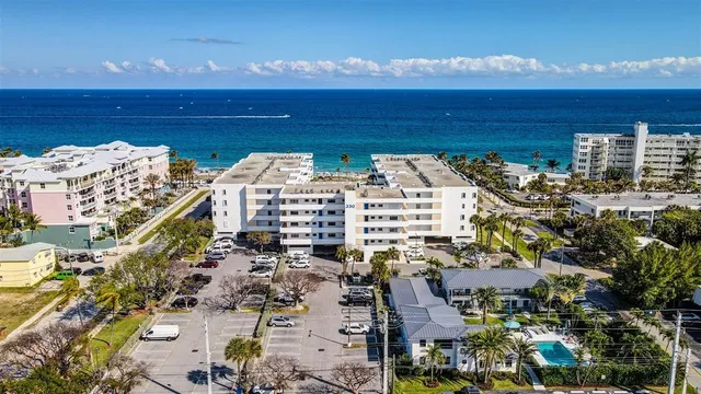 a view of swimming pool with outdoor seating and potted plants