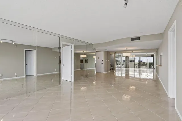 a bathroom with a double vanity sink and mirror with toilet