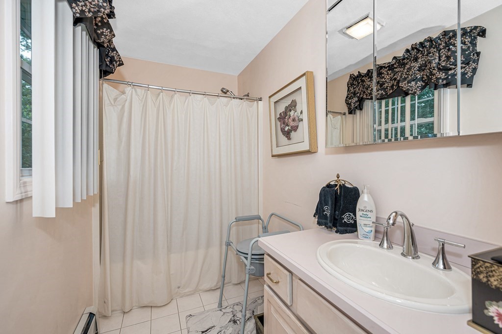 49 Susan Drive Saugus, MA 01906 - Photo 18 of 33 a bathroom with a sink and a mirror
