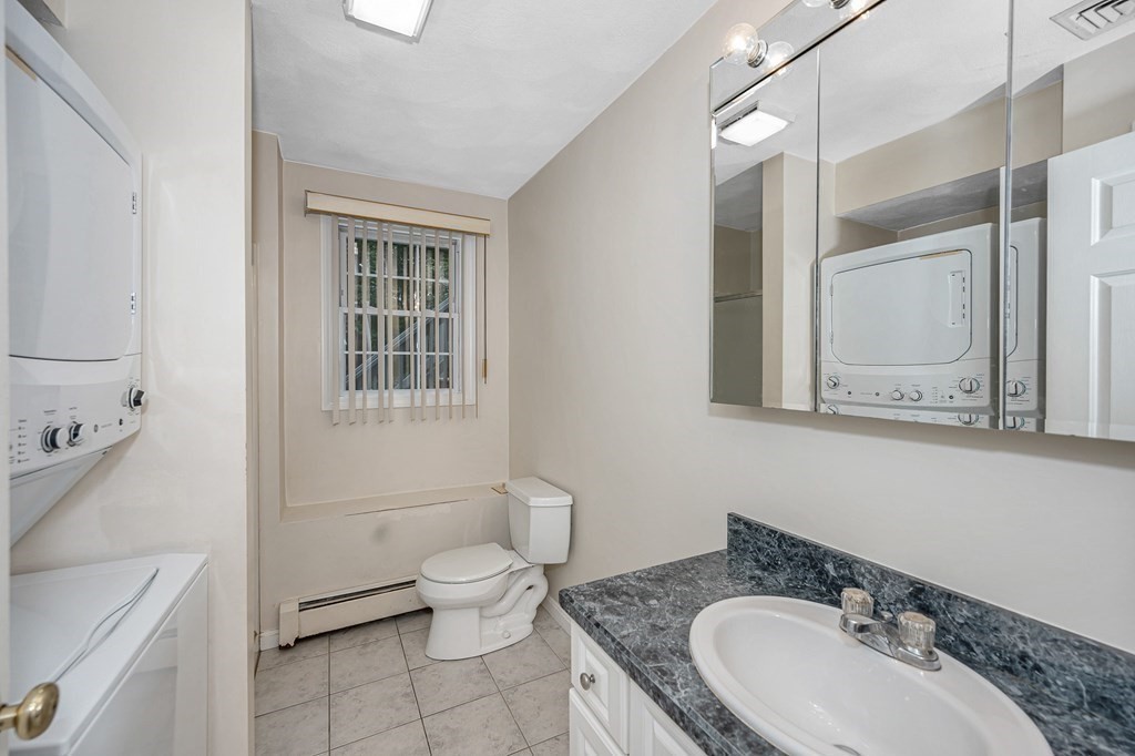 49 Susan Drive Saugus, MA 01906 - Photo 31 of 33 a bathroom with a granite countertop sink toilet a mirror and shower