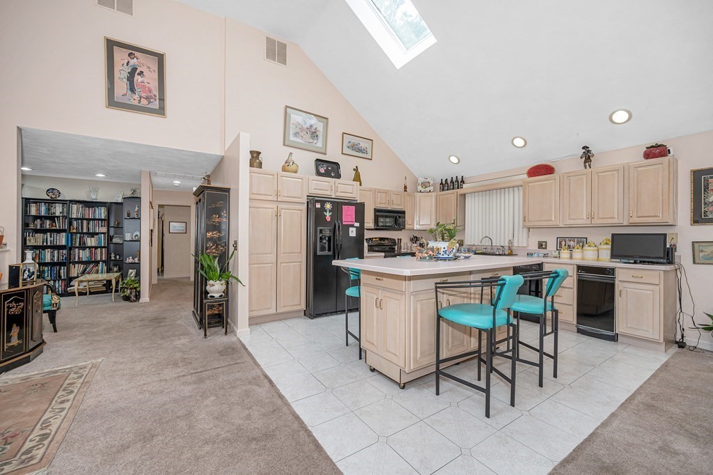 49 Susan Drive Saugus, MA 01906 - Photo 7 of 33 a kitchen with stainless steel appliances kitchen island granite countertop a table chairs sink and cabinets