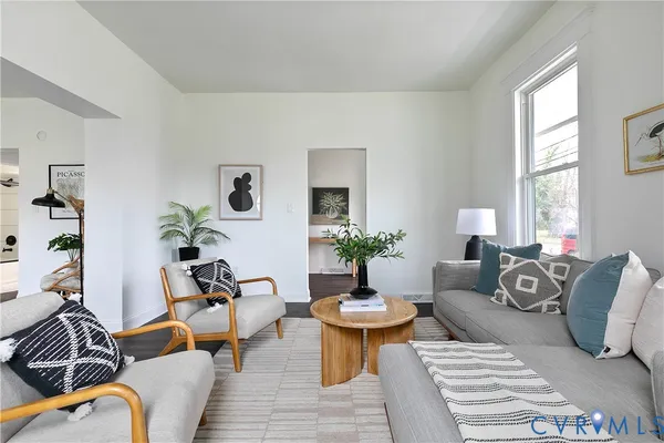 a view of a livingroom with furniture and a potted plant
