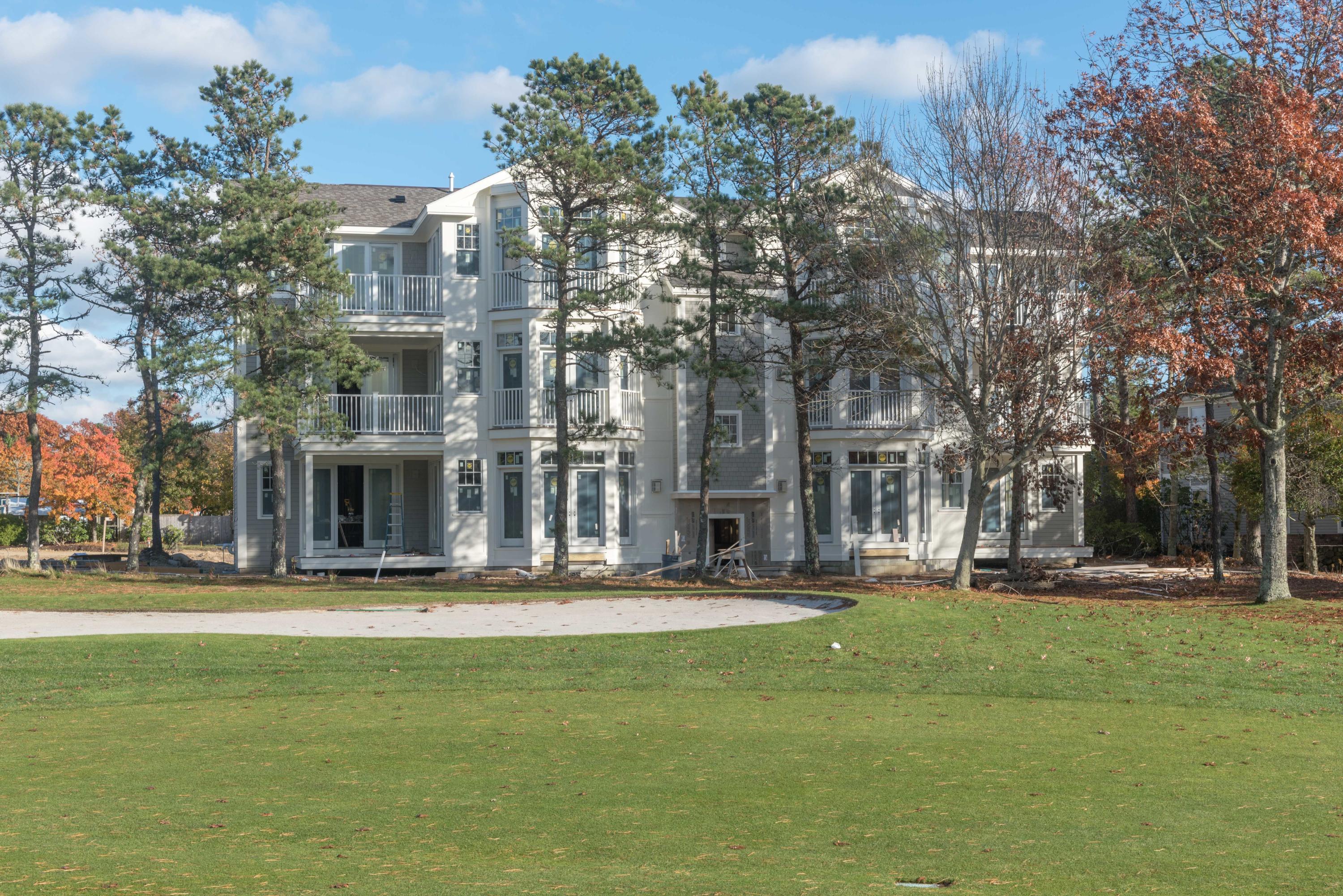 a front view of a building with trees