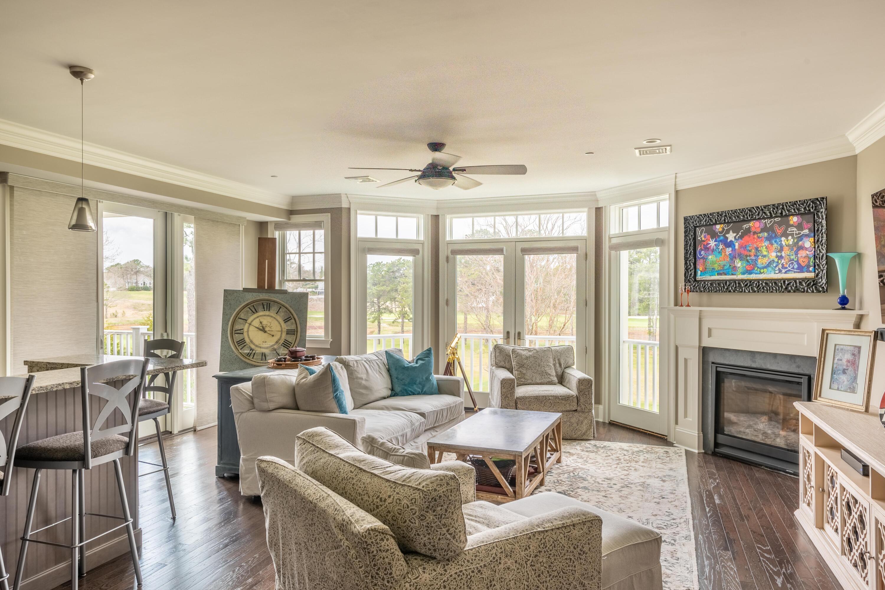 66 Simons Road, Unit C Mashpee, MA 02649 - Photo 3 of 11 a living room with furniture large window and a fireplace