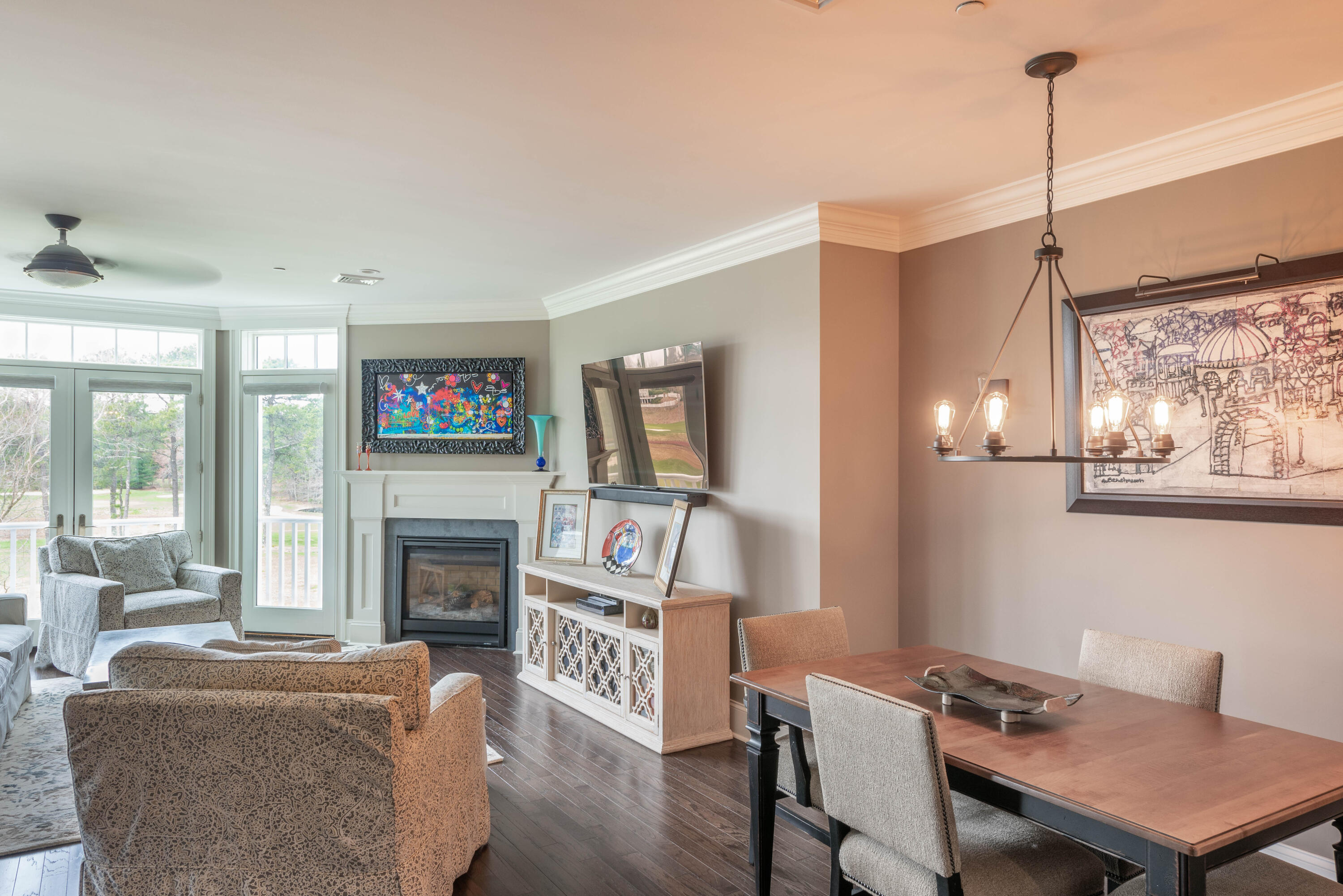 66 Simons Road, Unit C Mashpee, MA 02649 - Photo 5 of 11 a living room with furniture a flat screen tv and a fireplace