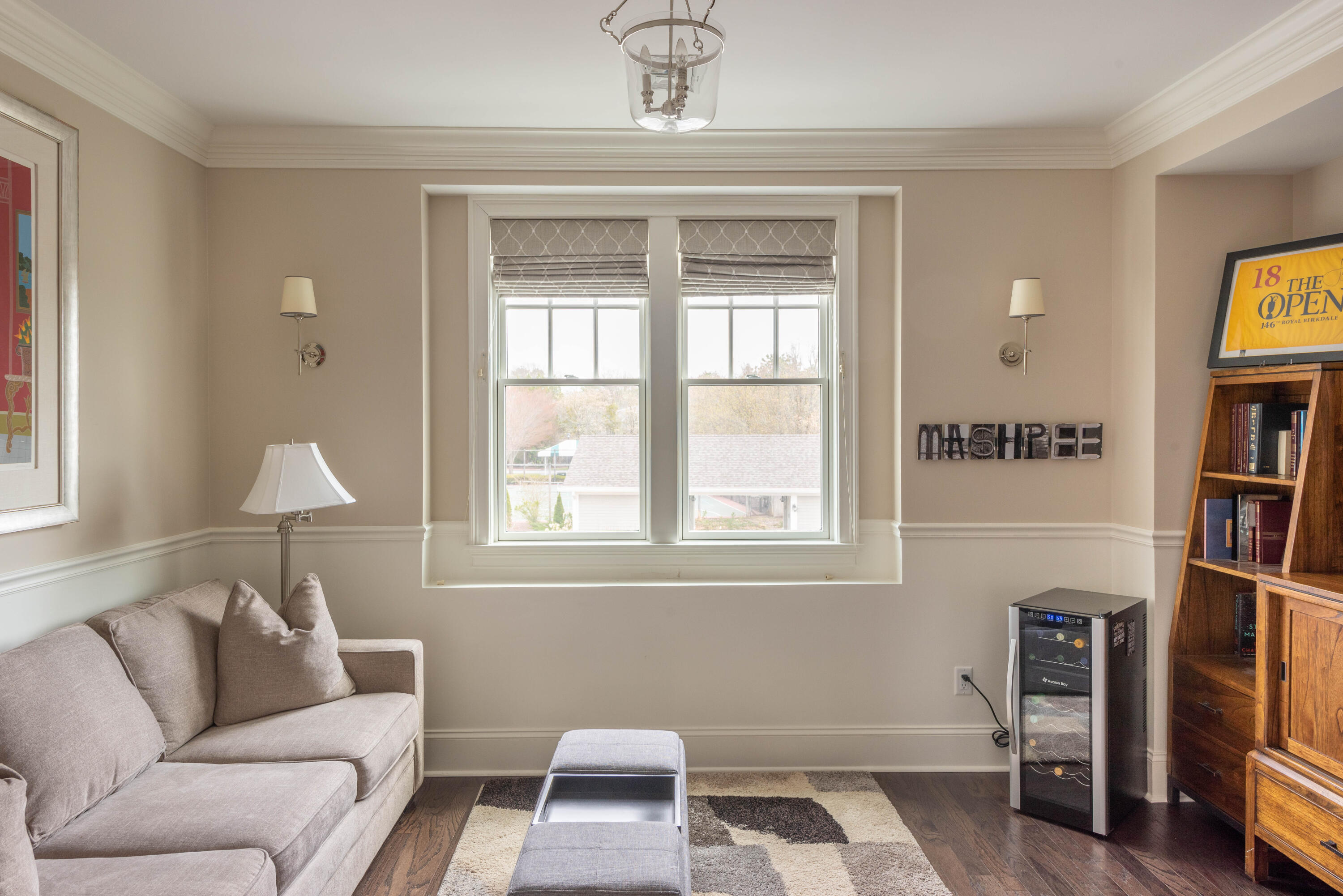 66 Simons Road, Unit C Mashpee, MA 02649 - Photo 10 of 11 a living room with furniture a window and a bookshelf