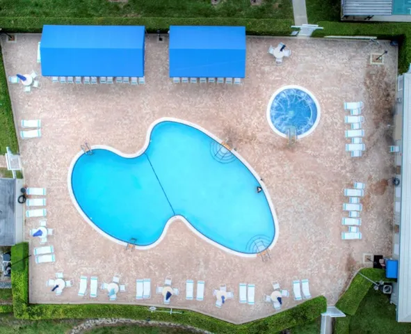an aerial view of a house with yard swimming pool and outdoor seating