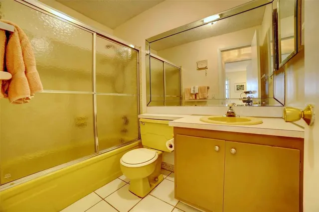 a bathroom with a sink mirror toilet and bathtub