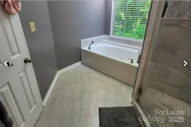 a bathroom with a bathtub and shower