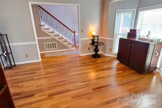 a view of a room with wooden floor and windows